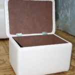 Open rectangular pouf with a box on wheels in the hallway
