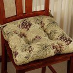 Pillow with bunches of grapes on a kitchen chair