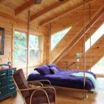 Suspended bed with purple bedspread