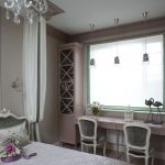 Elegant bedroom for two girls with two tables at the window