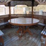 Round shaped wooden table - one of the most popular solutions for gazebos