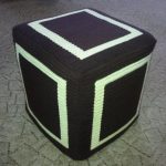 Knitted cubic pouf with filling from plastic bottles
