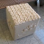 Knitted ottoman in the form of a cube