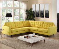 Yellow corner sofa sa tabi ng window