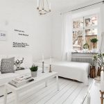 White living room with white furniture along one wall.