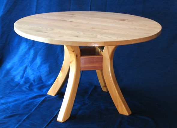 Round table with a design on four supports