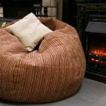 Armchair bag with a pillow by the fireplace
