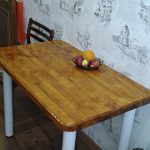 Table with wooden lacquer top in the kitchen