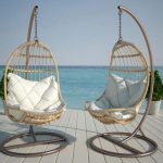 Suspended rattan chair with cushions