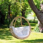 Suspended chair with wooden frame and soft pillows