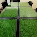 Praktisk udgave med kunstgræs skjult under bordglas