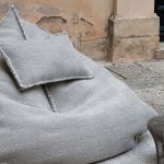 Gray ottoman bag with a pillow
