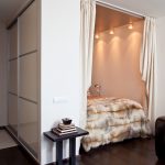 The sliding wardrobe creating a niche for a bed