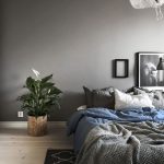 The minimalism style in the interior design of the bedroom is created by a small amount of furniture.