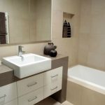 Bathroom in beige tones with an unusual washbasin