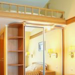 Wooden bed above the wardrobe