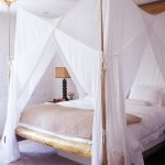 Bed with a canopy of wooden bars
