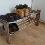 Shoe shelf of boards and metal pipes