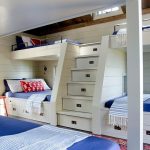 Boxes under the beds and in the steps for a compact room for several children