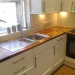 White kitchen with natural wood worktop