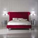 Large burgundy headboard for a soft bed