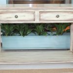 Wooden console table with carved legs and drawers