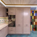Interesting kitchen design with high cabinets and country-style canisters