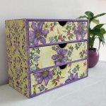 Cardboard chest of drawers with purple flowers