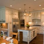 Kitchen with an island and high cabinets to the ceiling
