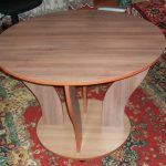 Low round table with figured legs from chipboard