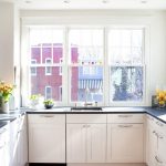 U-shaped kitchen along windows without wall cabinets