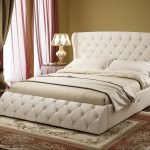 Chic soft bed with capitone decor in the bedroom