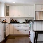 Cabinets to the ceiling in the white modern kitchen
