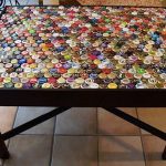 Decorating the surface of the kitchen table with bottle caps