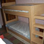 Bed from chipboard in two tiers