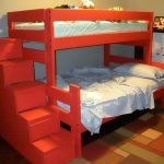 A bed in two tiers with a chest of drawers in red