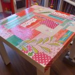 Square table with a renewed tabletop using decoupage technique