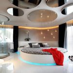 Round mirror fragments on the ceiling in a spacious bedroom