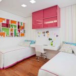 Pink shelf with sliding doors in the nursery for girls