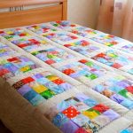 Beige bedspread with multi-colored square patchwork patchwork