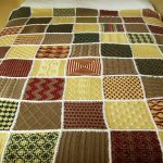 Large plaid on a bed of various knitted motifs