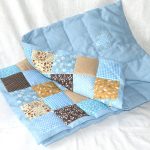 Blue blanket with colorful patchwork accents