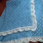 Blue blanket with white edging for a boy