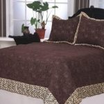 Brown bedspread and pillows with decor