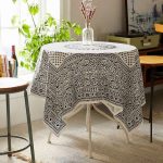 Square tablecloth with geometric patterns on a round table