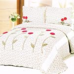 Spathe on the bed with small floral pattern and large decorative flowers