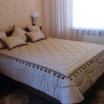 Durable and heavy bedspread on the bed with a fringe