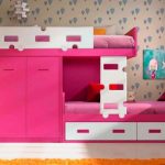 Pink and white bed with a wardrobe for two children