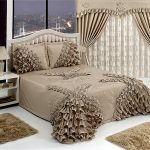 Curtains and bedspread on the bed with beautiful decorative elements