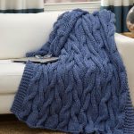 Blue knitted blanket with repeating knitting pattern